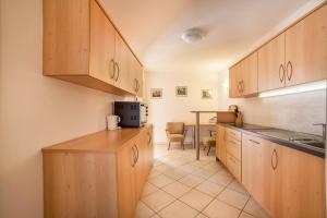 a kitchen with wooden cabinets and a counter top at Parigger Apt Zirbe in Racines