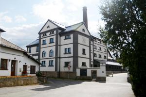 a large white building with a clock tower on it at Pivovar Tupadly in Tupadly