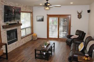 a living room with a couch and a fireplace at Cheerful Kathys Cabin, King Bed, Hot Tub, Close to NAU, Airport & Hiking Trails! in Flagstaff