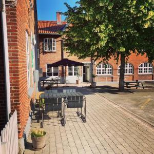 a group of benches sitting on a brick building at Danhostel Haderslev in Haderslev