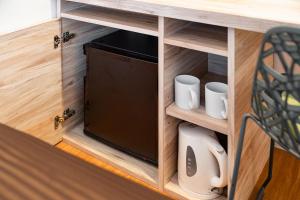 a cupboard with a television in a room at The OneFive Fukuoka Tenjin in Fukuoka