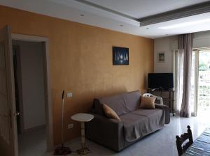 ein Wohnzimmer mit einem Sofa und einem TV in der Unterkunft Appartamento Marchese in Racalmuto