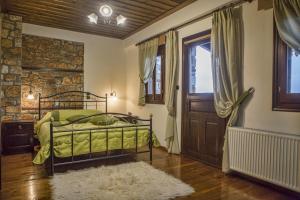 una camera da letto con un letto, una finestra e una porta di T'Asprolithia a Kalyvia Fylaktis
