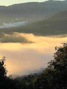 a view of a valley with clouds in the sky at Apartamento rural El Pastor es un estudio con gran ventanal a Gredos in Cabezas Bajas