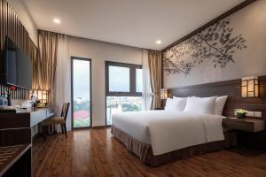 a bedroom with a large bed and a large window at Authentic Hanoi Boutique Hotel in Hanoi