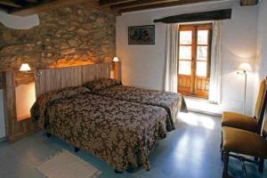 A bed or beds in a room at EL Molino de Tormellas exclusivo alojamiento rural en un antiguo molino