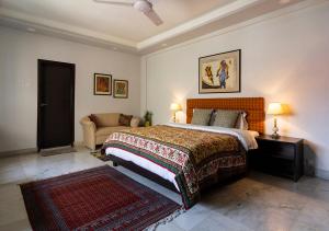 - une chambre avec un lit king-size et un canapé dans l'établissement Neelam Bed & Breakfast, à Kolkata