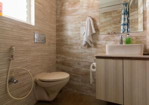 a bathroom with a toilet and a sink at Neelam Bed & Breakfast in Kolkata