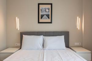 a bedroom with a bed with two white pillows at Sea Stories Apartments Varna in Varna City