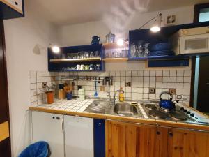 a kitchen with a sink and a counter top at M & M apartment Krvavec in Cerklje na Gorenjskem +26 photos