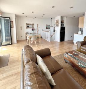 a living room with a couch and a table at The Beach House Broadstairs in Broadstairs