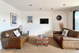 a living room with two couches and a coffee table at The Beach House Broadstairs in Broadstairs