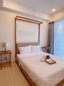 a bedroom with a bed and a window at vitamin SEA Timurbay Residence in Kuantan