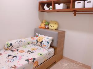 a childs bedroom with a bunk bed and shelves at vitamin SEA Timurbay Residence in Kuantan