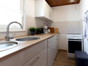 a kitchen with a sink and a counter top at Ferienbungalow Schultz in Altenkirchen in Altenkirchen