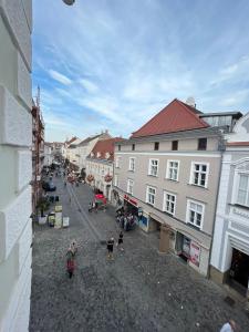a city street with buildings and people walking on the street at Hagmann's Altstadt Appartement in Krems an der Donau