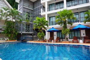 a swimming pool in front of a building at Sabai Hotel Aonang in Ao Nang Beach