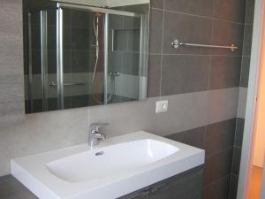a bathroom with a white sink and a shower at B&B Stazione in Canegrate