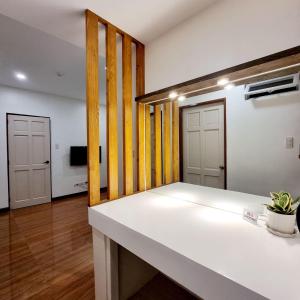 a room with a white counter and two doors at Eekos Hotels in Baguio