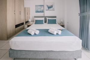 a bedroom with a large bed with towels on it at Joy Apartment in Rethymno