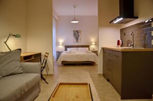 a kitchen and a bedroom with a bed in a room at Eutopia Luxury Studio in Kavala