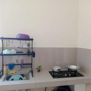 a kitchen with a counter and a stove and a sink at Lavanta Guest House 