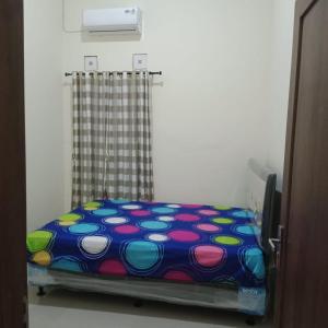 a bed with a polka dot blanket in a room at Lavanta Guest House 
