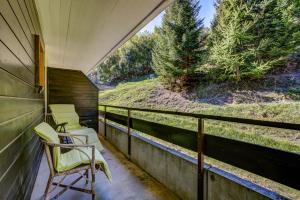 a porch with chairs and a view of trees at Appartement Savoleyres 30 in La Tzoumaz