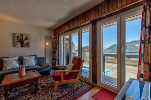 a living room with a couch and a window at Appartement Savoleyres 30 in La Tzoumaz