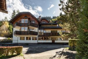 a house in the mountains with trees at Appartements Planai by Schladmingurlaub in Schladming