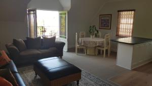 a living room with a couch and a table at Mountain View Self-Catering Apartment in Somerset West