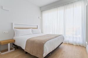 Łóżko lub łóżka w pokoju w obiekcie Uma Suites O'Donnell