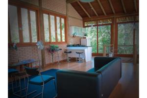 a living room with a couch and a table and chairs at OYO Pousada e Hotel Putini in São Roque