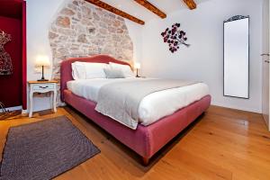 a bedroom with a bed and a dresser at Apartments Casa De Amicis in Rovinj