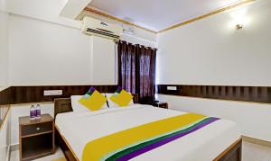 a bedroom with a large bed with a colorful blanket at Itsy By Treebo - HSR Comfort in Bangalore