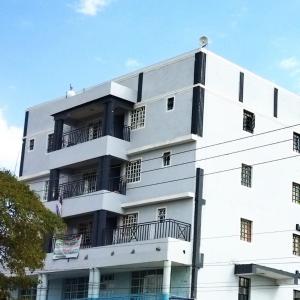 a white building with balconies on the side of it at Essie Studios Naivasha CBD in Naivasha