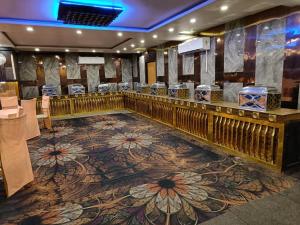 a bar with a floral carpet in a room at Hotel APJ GRAND in Faridabad
