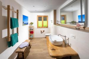a bathroom with a sink and a mirror at Rauchenbichlhof in Ruhpolding +30 photos