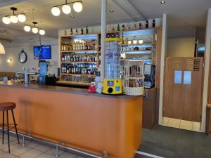 a bar in a restaurant with a counter at CAFE DE PARIS in Lesparre-Médoc