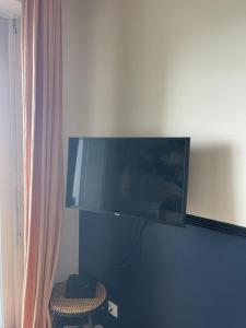 a flat screen tv hanging on a wall at Rosa*Studio *Belle Vue Mer*Dinard* in Dinard
