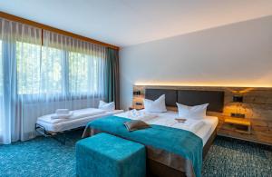 Voodi või voodid majutusasutuse Das Wiesgauer - Alpenhotel Inzell toas