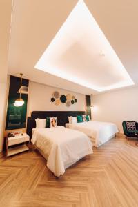 two beds in a room with a skylight at La Seine Hotel in Vientiane