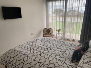 a bedroom with a large bed and a window at 1 The Bay - Stunning contemporary flat on the Scottish coast in Coldingham
