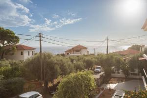 a view of the ocean from a house at Remvi Hotel - Apartments in Stoupa