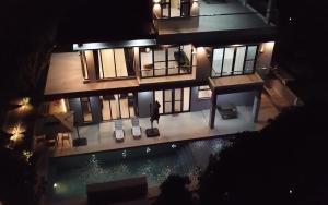 an aerial view of a house with a swimming pool at Mangolia Farm in San Juan