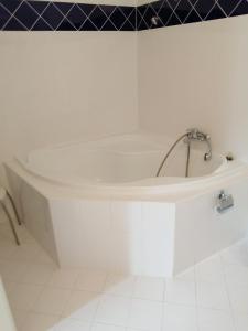 a white bath tub with a faucet in a bathroom at Apartmany Cesky Dvur in Mariánské Lázně