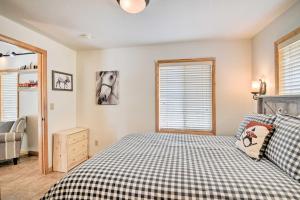a bedroom with a bed and a window with a horse picture at 4 Mi to Grand Lake Mtn-View Cabin with Fire Pit! in Grand Lake