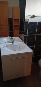 a bathroom with a white sink and a toilet at Maison cœur tarentaise in Les Chapelles