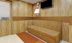 a small room with a bench and a tv at Itsy By Treebo - HSR Comfort in Bangalore
