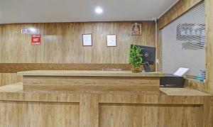a reception desk in an office with wooden walls at Itsy By Treebo - HSR Comfort in Bangalore